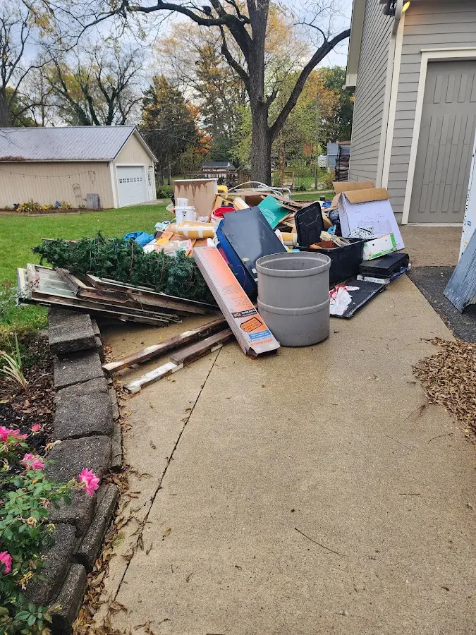 Dumpster being loaded with debris for 12 Yard Dumpster Rental in La Grande